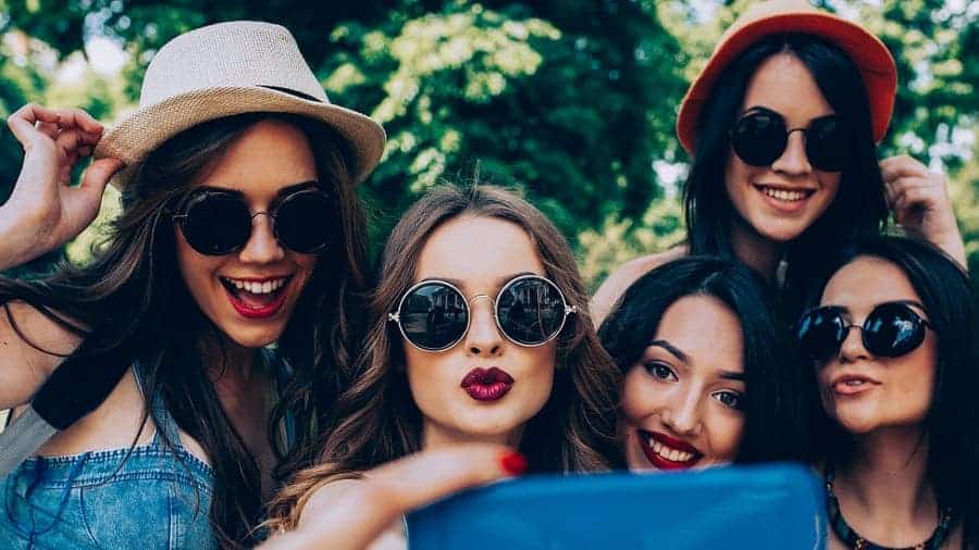 five beautiful young girls make selfie in the park